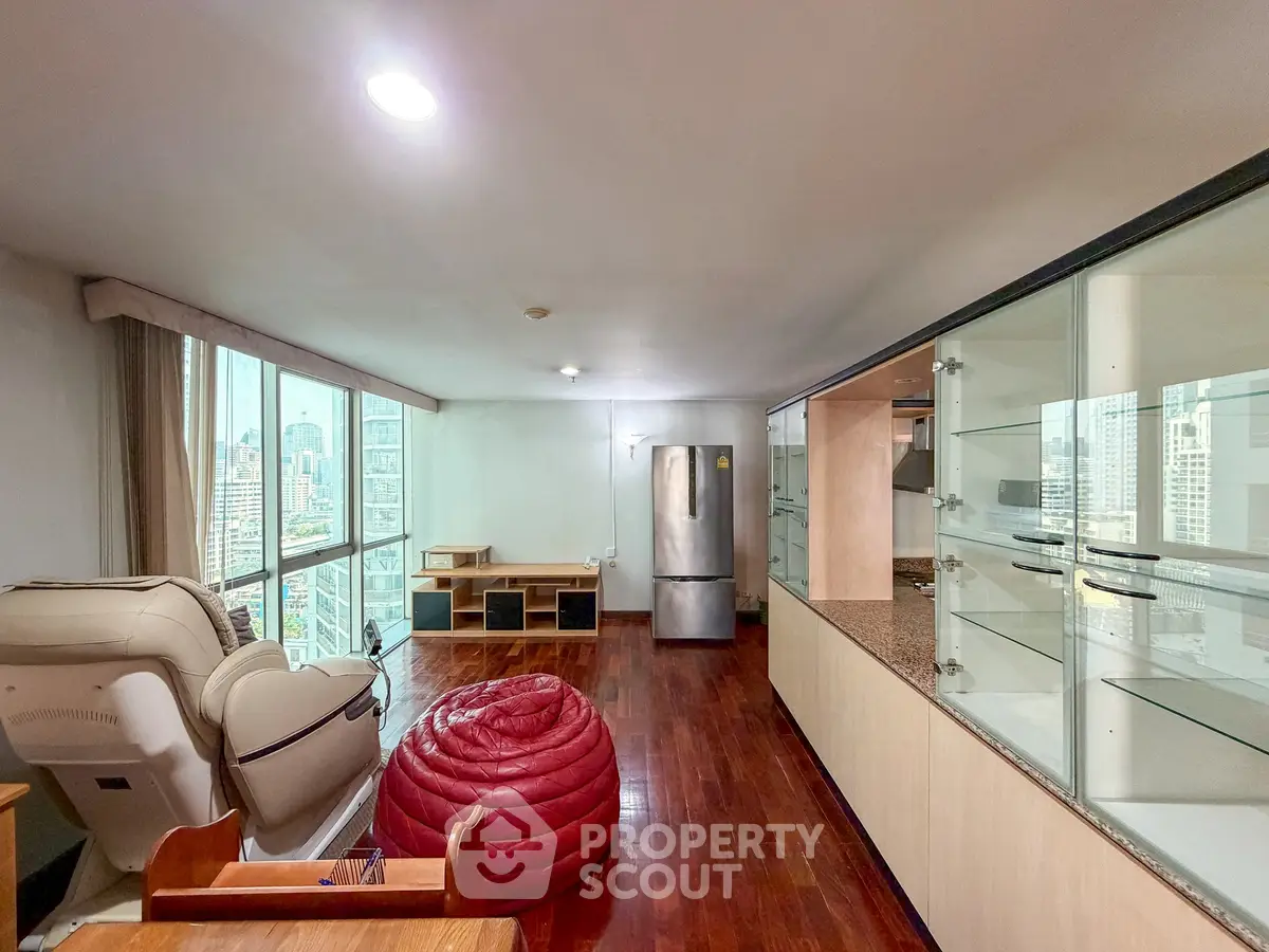 Spacious living room with city view and modern furnishings