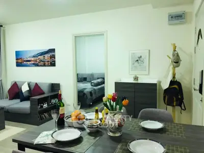 Charming open-plan living and dining area with modern decor and cozy ambiance.