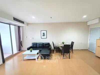 Spacious living room with modern furniture and dining area in a stylish apartment.