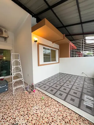Modern outdoor patio with tiled flooring and stylish lighting, perfect for relaxation and entertainment.
