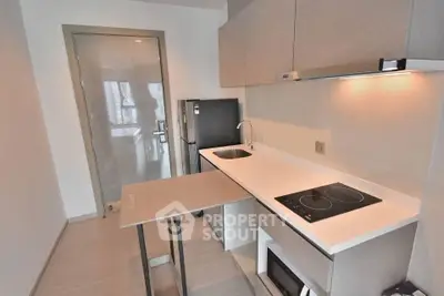 Modern compact kitchen with sleek design and built-in appliances