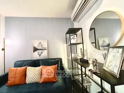 Stylish living room with modern decor, featuring a plush sofa, elegant shelving, and chic wall art.