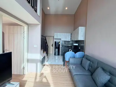 Modern loft apartment with high ceilings, stylish kitchen, and cozy living area.