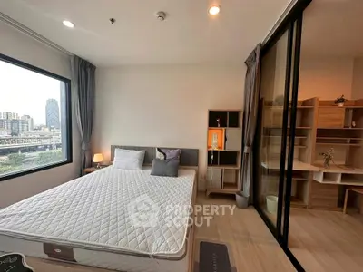 Modern bedroom with city view and adjacent study area