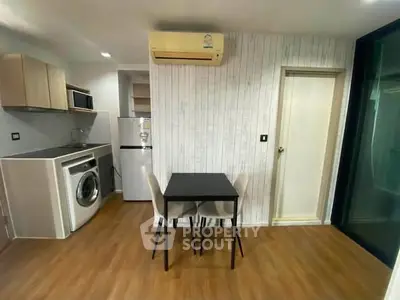 Modern compact kitchen with washing machine and dining area in stylish apartment