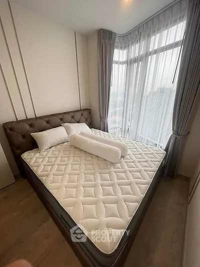 Modern bedroom with large window and stylish bed in high-rise apartment