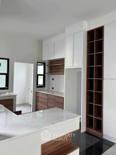 Modern kitchen with sleek cabinetry and marble countertops in a contemporary home.