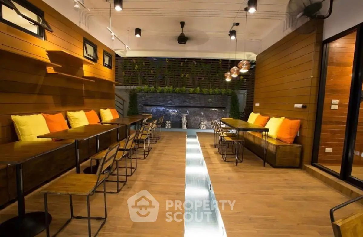 Modern indoor seating area with stylish lighting and wooden accents