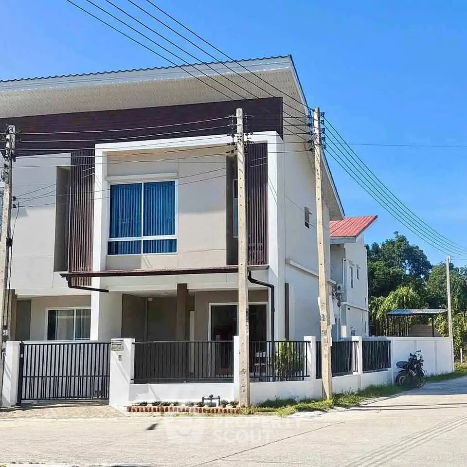 Modern two-story house with sleek design and spacious outdoor area in a serene neighborhood.