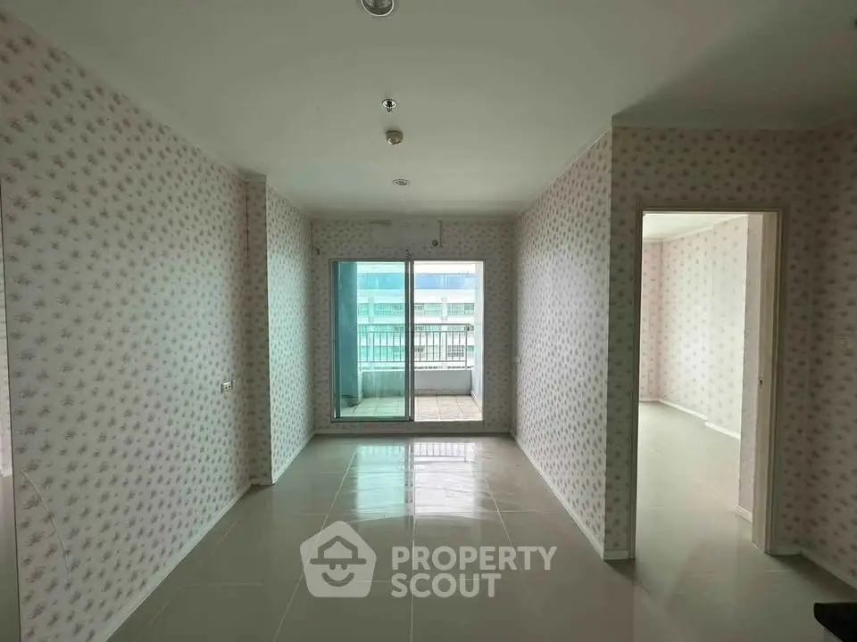 Spacious unfurnished apartment with balcony and large windows for natural light.