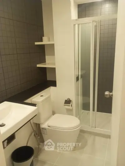 Modern bathroom with sleek shower and contemporary fixtures in a stylish apartment.