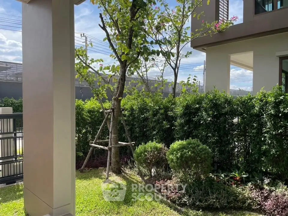 Charming garden view with lush greenery and modern architecture, perfect for serene outdoor living.