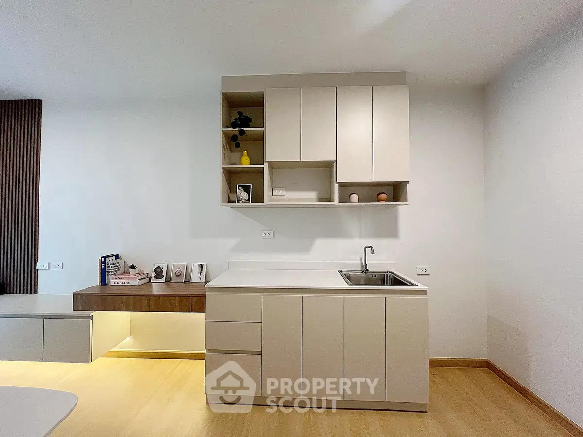 Modern minimalist kitchen with sleek cabinetry and integrated sink