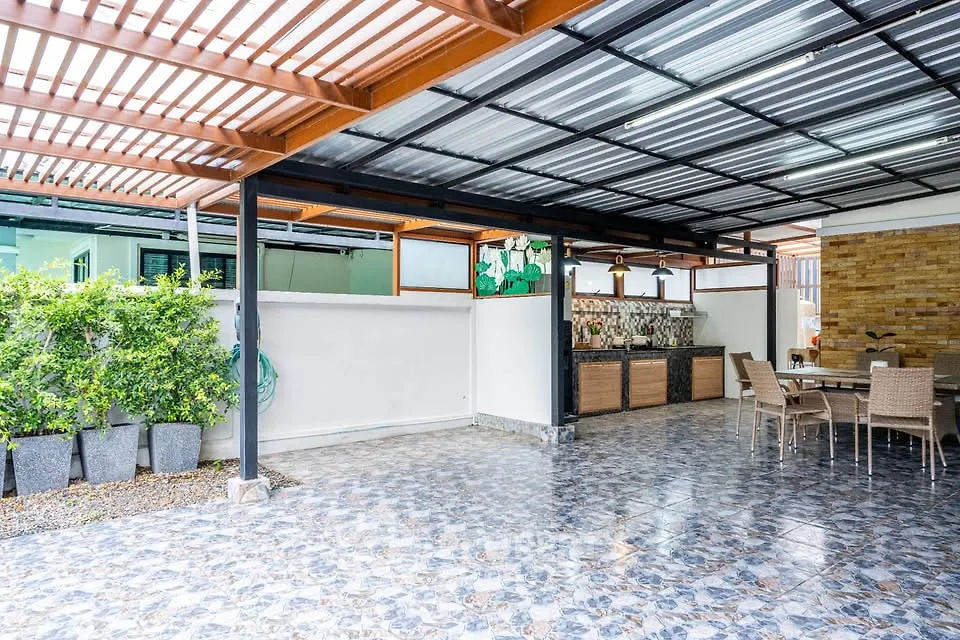 Spacious covered patio with modern outdoor kitchen and dining area.