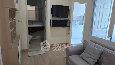 Cozy living room with modern decor and adjacent kitchen view