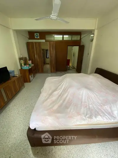 Spacious bedroom with modern furnishings and ample storage space.