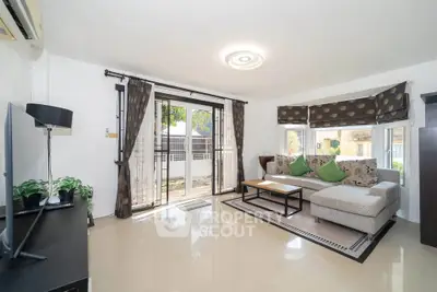 Spacious living room with modern decor and large windows for natural light.