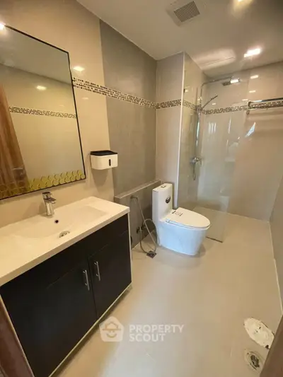 Modern bathroom with sleek fixtures and glass shower enclosure