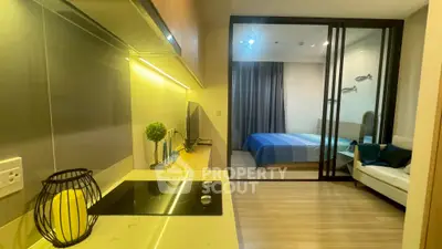 Modern studio apartment with sleek kitchen and cozy bedroom