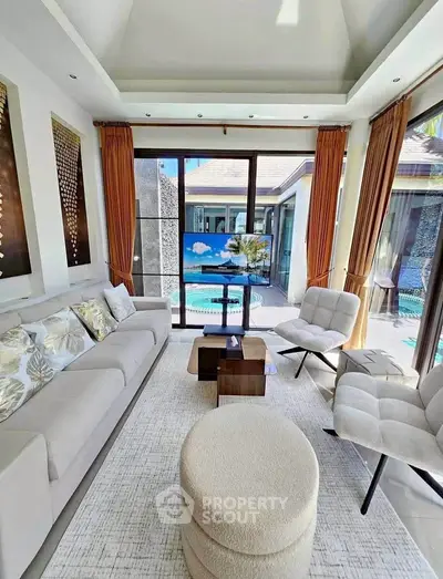Luxurious living room with pool view, modern furniture, and elegant decor in a serene setting.