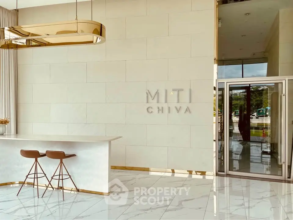 Elegant modern building entrance with sleek design and stylish bar stools