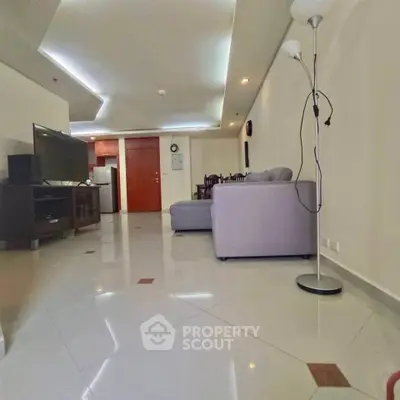 Spacious living room with modern lighting and sleek flooring