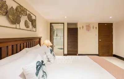 Spacious bedroom with elegant decor and cozy ambiance in a modern real estate property.