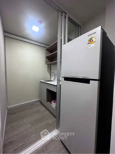 Modern kitchen with sleek fridge and compact design