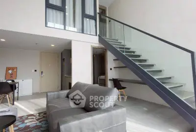 Modern duplex living room with sleek staircase and stylish furniture