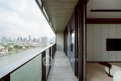 Luxurious high-rise balcony with stunning city and river views, perfect for urban living.