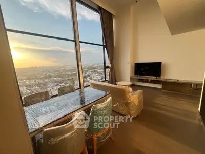 Luxurious high-rise living room with stunning city view and modern furnishings.