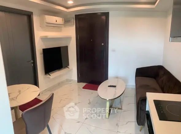 Modern living room with sleek furniture and marble flooring in a stylish apartment.