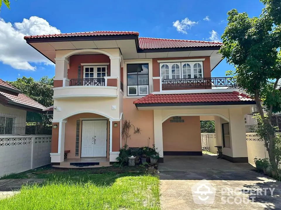 Charming two-story house with red roof and spacious driveway in a serene neighborhood.