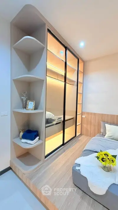 Modern bedroom with built-in shelving and cozy bed setup