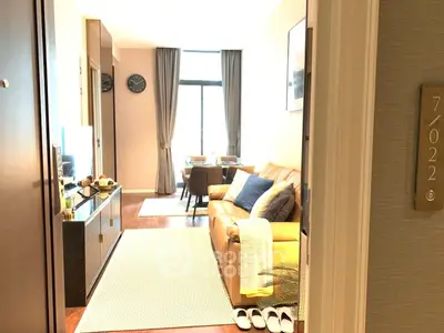 Modern living room with cozy seating and natural light in a stylish apartment.