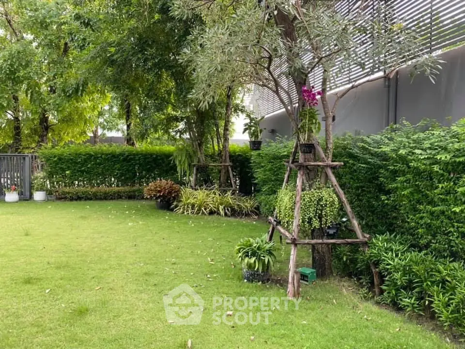 Lush green garden with manicured lawn and decorative plants, perfect for relaxation and outdoor activities.