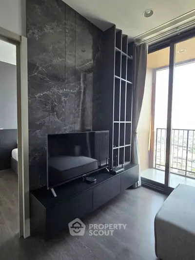 Modern living room with sleek black TV stand and large window balcony view