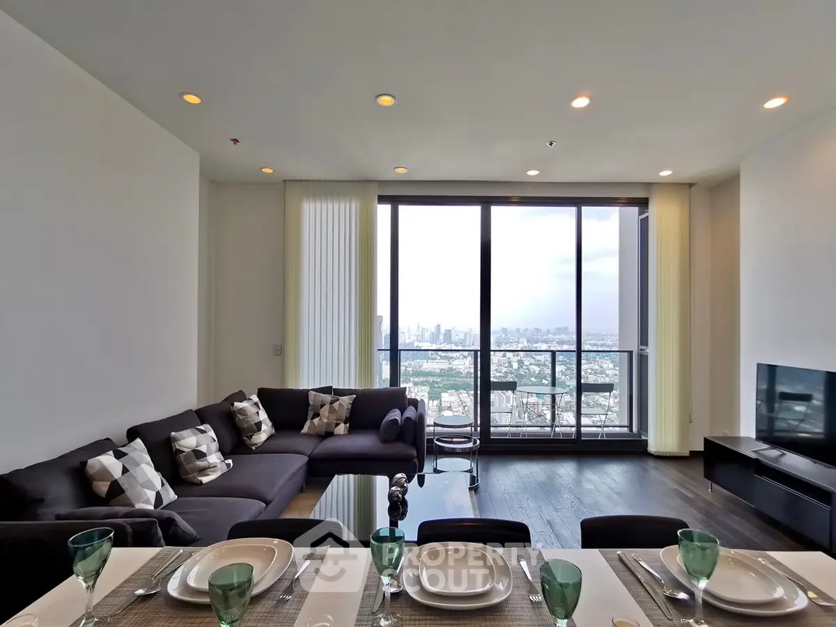 Luxurious living room with stunning city view and elegant dining setup