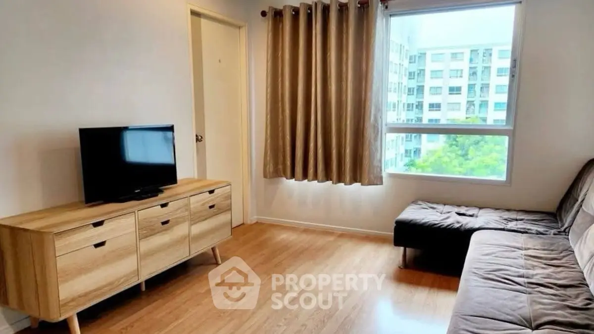 Modern living room with wooden flooring and large window view