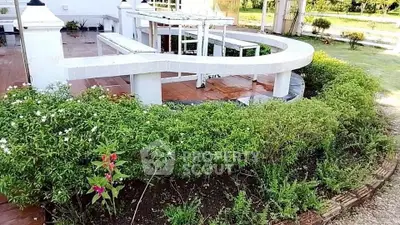 Charming garden with a unique curved patio design, perfect for outdoor relaxation and entertainment.