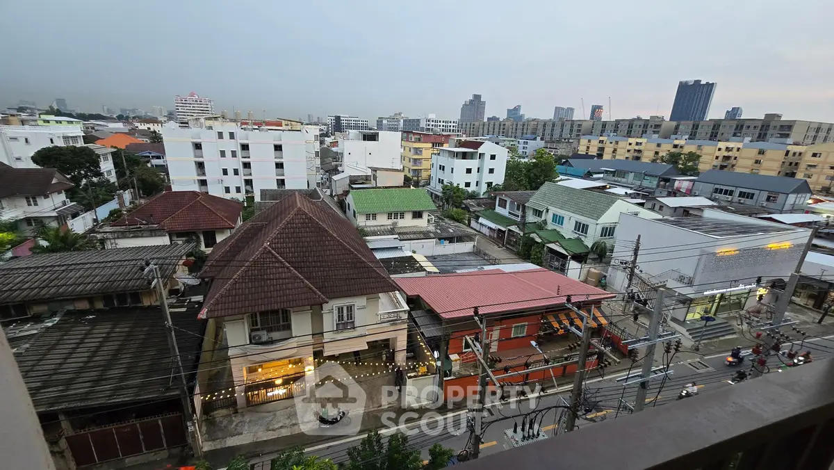 Stunning cityscape view from a high-rise balcony showcasing diverse architecture and urban skyline.