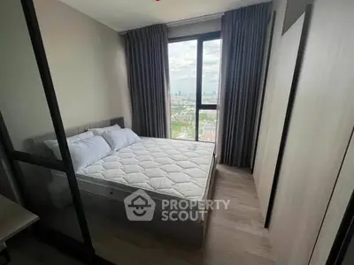 Modern bedroom with large window offering stunning city views, featuring a comfortable bed and sleek design.