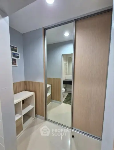 Modern bathroom with sliding mirror door and stylish storage solutions.