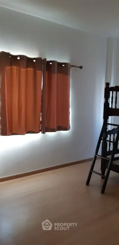 Minimalist bedroom with wooden bunk bed and warm curtains, perfect for cozy living.