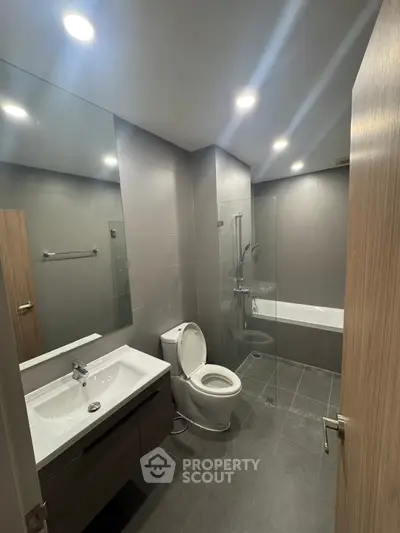 Modern bathroom with sleek fixtures and glass shower enclosure