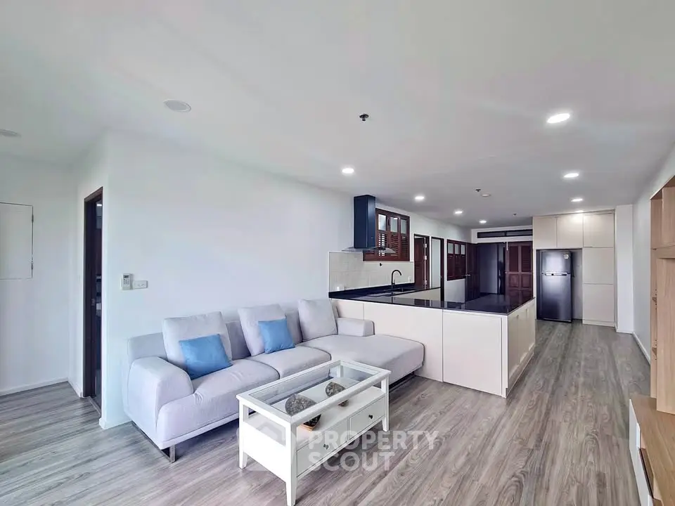 Spacious modern living room with open kitchen and sleek design