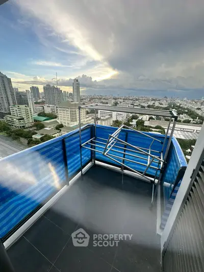 Stunning cityscape view from a high-rise balcony with modern railing and expansive skyline.