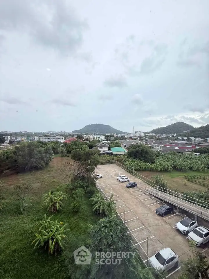 Scenic view of residential area with lush greenery and parking lot, perfect for serene living.