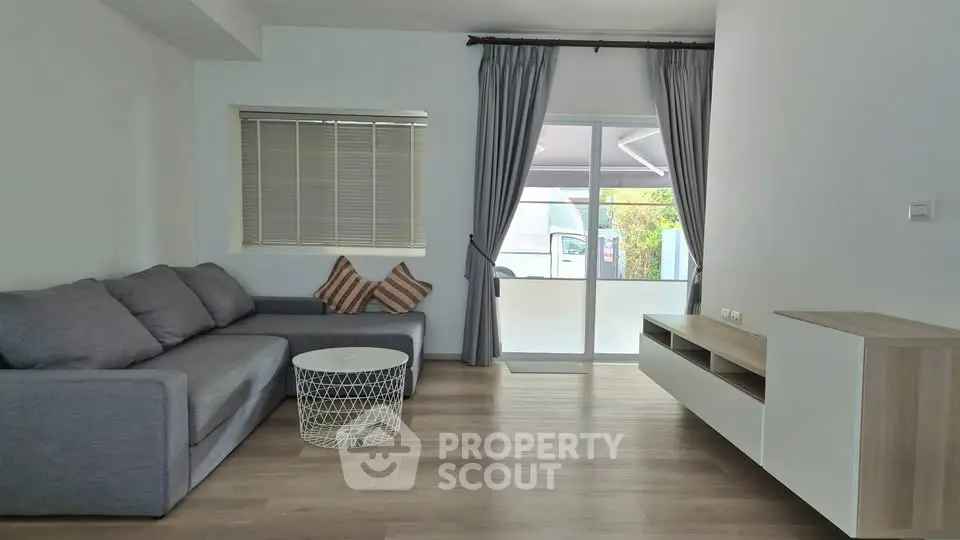 Modern living room with stylish gray sofa and sleek wooden flooring