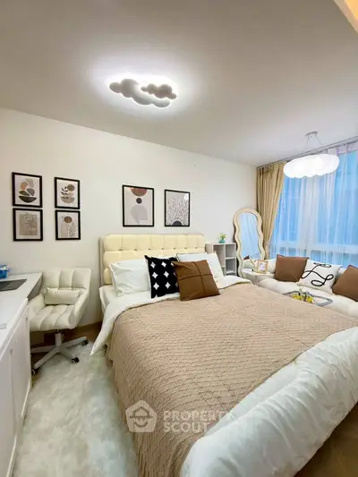 Cozy bedroom with stylish decor and plush bedding, featuring modern lighting and elegant wall art.
